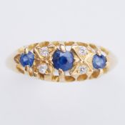 An 18ct yellow gold ring set with round cut sapphires interspaced by round cut white stones (not