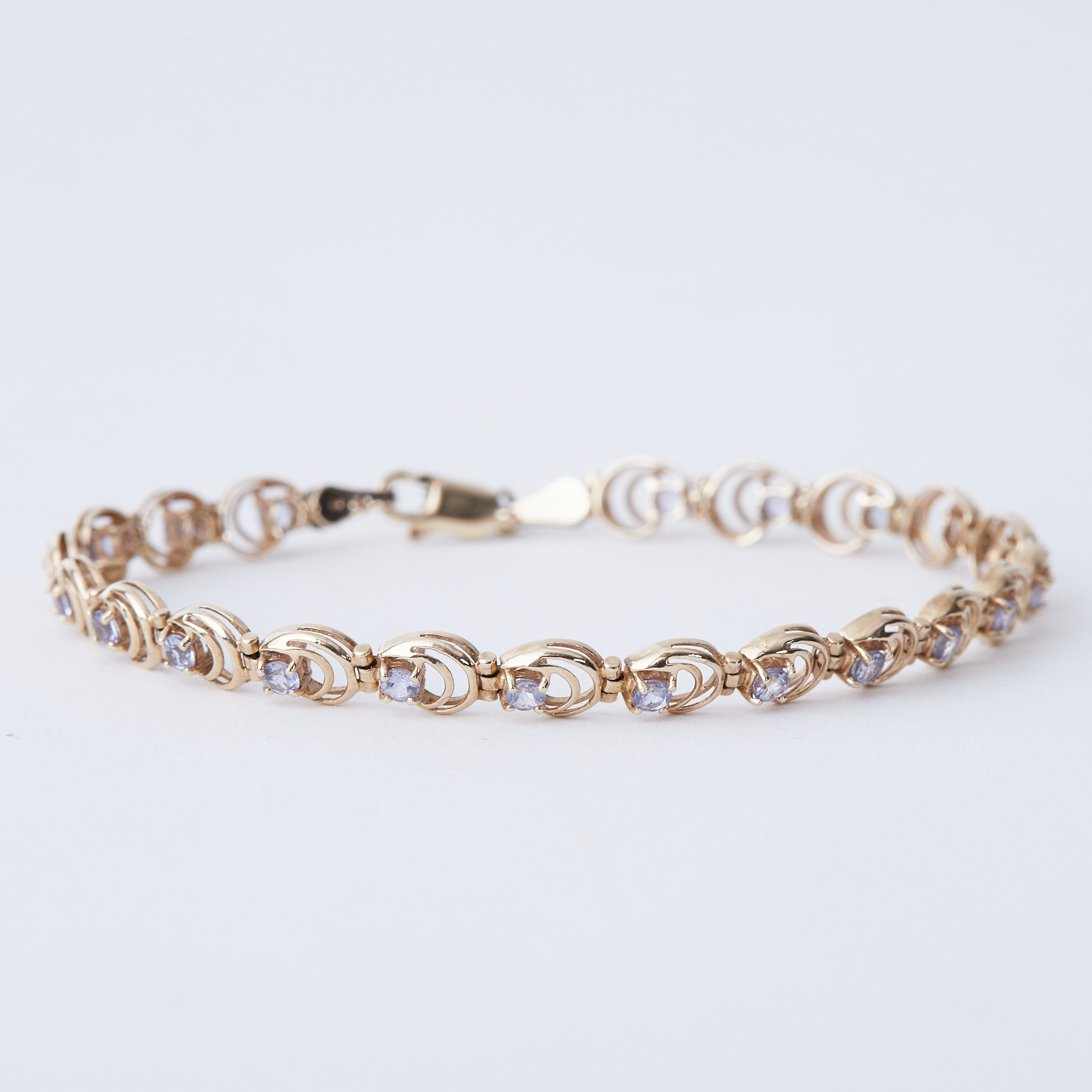 A 9ct yellow gold circular link bracelet set with small round tanzanite, length 18cm, 5.33gm.