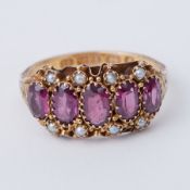 A Victorian 15ct yellow gold five stone ring set with oval cut amethyst/rhodolite garnet?
