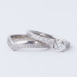 A platinum engagement ring set with a central round brilliant cut diamond, approx. 0.45 carats,