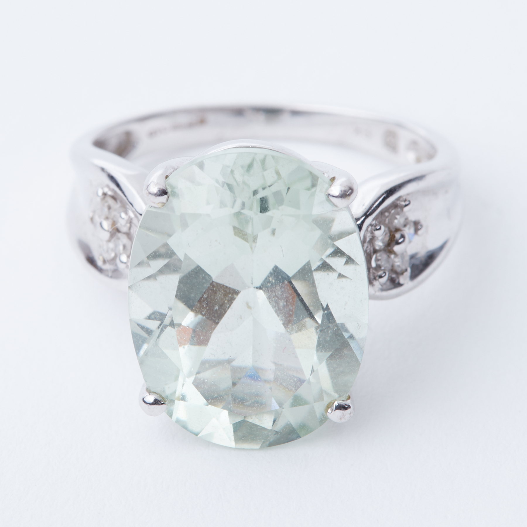 A 9ct white gold ring set with a central oval cut green stone (possibly green amethyst), approx.