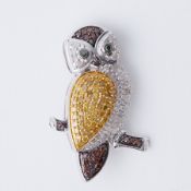 A silver owl brooch set with 1.05 carats of white, cognac, green & yellow diamonds,