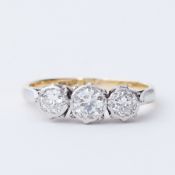 An 18ct yellow gold & platinum three stone ring set with three round brilliant cut diamonds, total