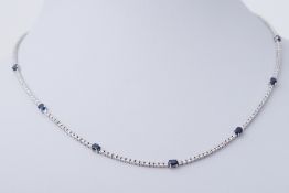 An 18ct white gold line necklace set with seven oval cut sapphires, total sapphire weight