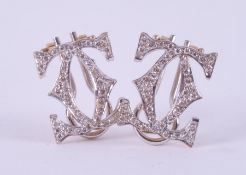 A pair of 18ct yellow & white gold earrings inspired by the Cartier double 'CC' design, set with