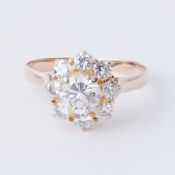 A yellow gold ring in a flower design set with round brilliant cut diamonds, total diamond weight