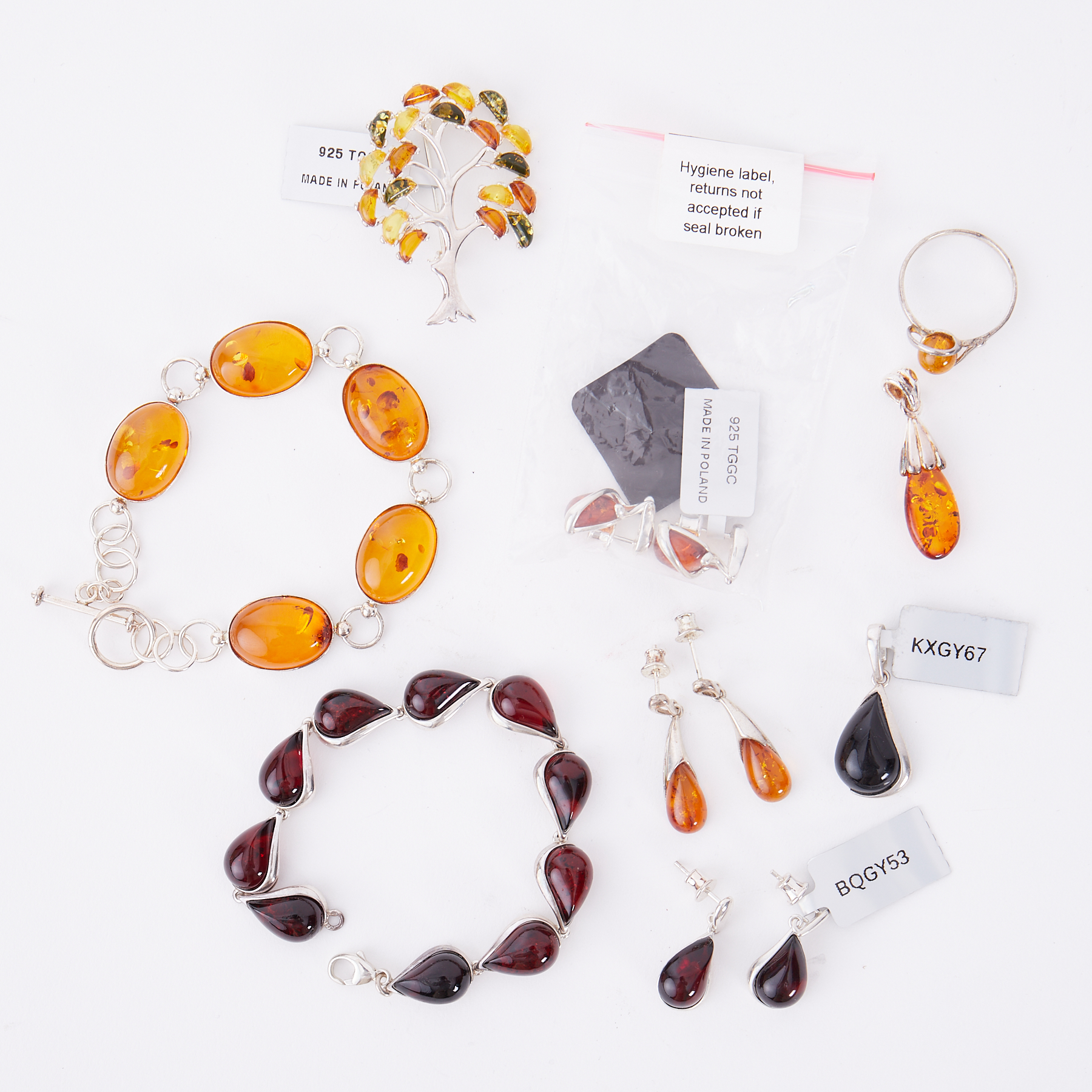 A mixed lot of silver & amber jewellery to include a tree brooch with mixed coloured amber, a Baltic