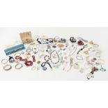 A large collection of costume jewellery to include earrings, faux pearls, necklaces, some silver