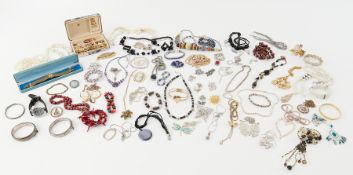 A large collection of costume jewellery to include earrings, faux pearls, necklaces, some silver