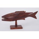 A carved model of a fish from Pitcairn Island (damaged fin), length 34cm.
