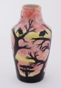 Moorcroft stoneware vase decorated with bird in trees, stamped Cobridge, 16.5cm.