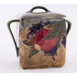 William Moorcroft early 'Pomegranate green ground twin handled Biscuit jar with replacement lid,