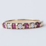 A 9ct yellow gold half eternity style ring set with round cut rubies approx. 0.12 carats and round