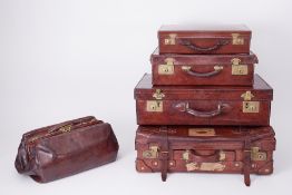 Six Vintage leather suitcases some with travel labels, one with maker label 'Kelvin' brand.