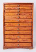 A table top collectors cabinet fitted with twelve drawers.