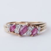 A 9ct yellow gold ring set with approx. 0.28 carats of marquise cut rubies and approx. 0.16 carats