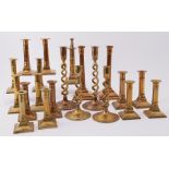 A collection of twenty-one 19th century and later brass candlesticks, mainly in pairs.