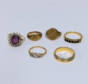 Six rings to include a 9ct yellow gold oval signet ring, a 9ct yellow gold cluster ring set