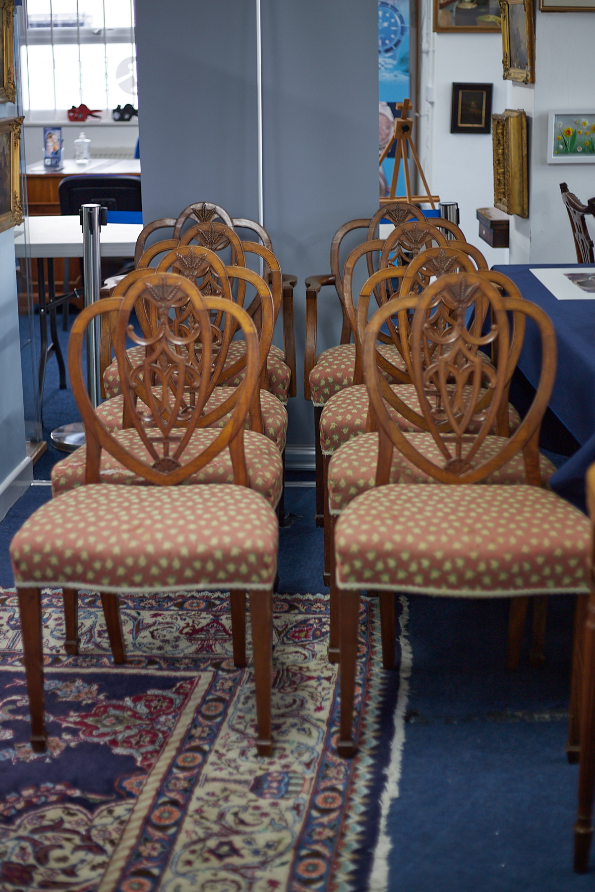 A set of eight mahogany framed dining chairs comprising six standards and two carvers with wheat
