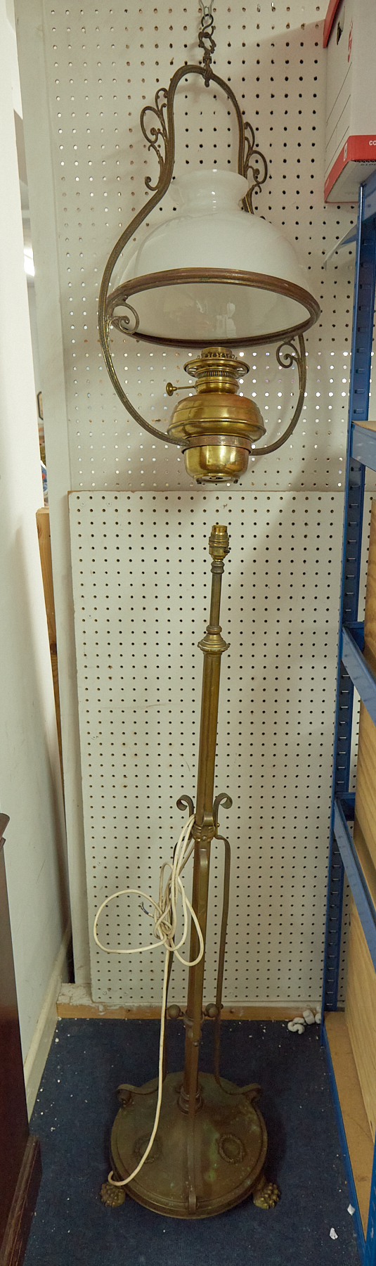 A brass floor standing rising lamp together with a hanging brass oil lamp with white shade (2)