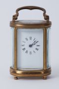 A miniature French carriage clock with platform escapement, height 8cm.