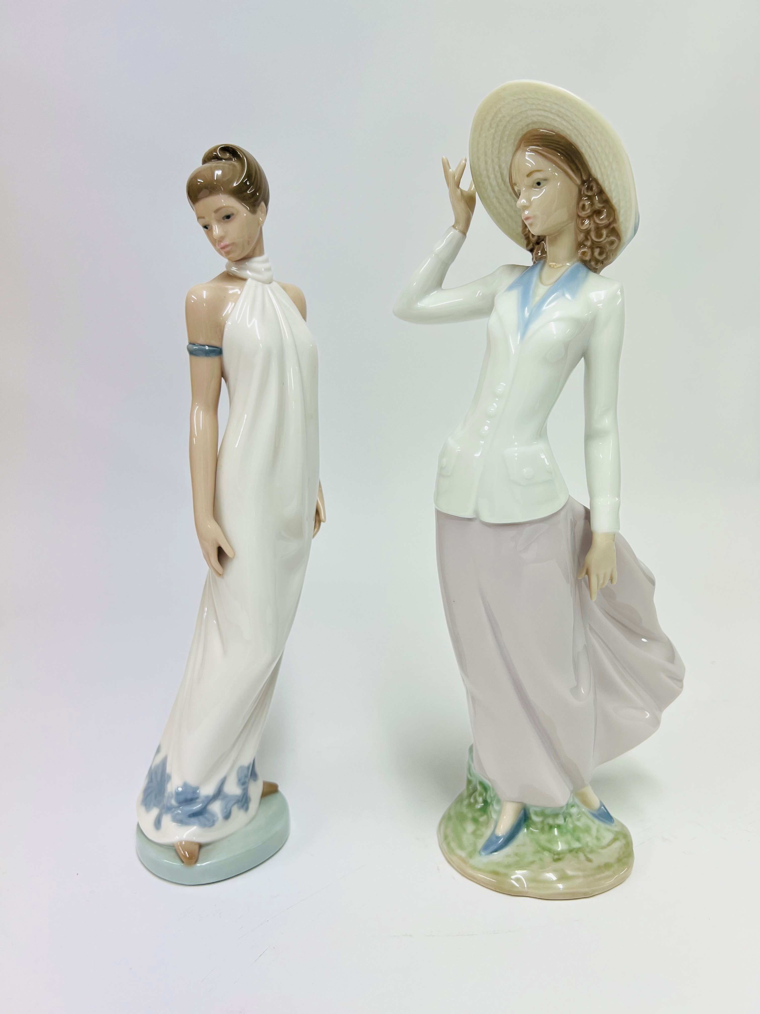 One Lladro lady figurine and a Nao lady figurine (damaged).