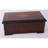 A Victorian single cylinder music box in inlaid cabinet (poor condition combe), width 19 inches.