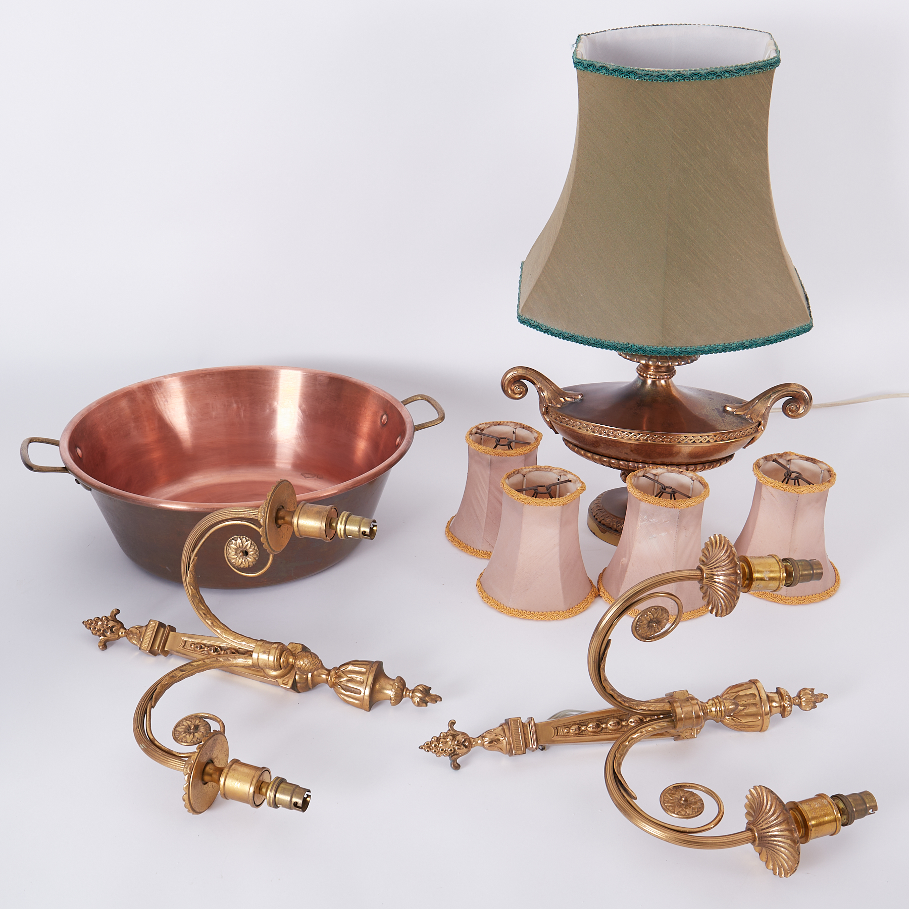 A copper jam pan, a pair of gilt brass wall lights and a table lamp, some shades