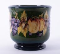 A Moorcroft planter decorated with fruit of the vine, No.240, height 18cm.