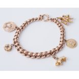 A 9ct yellow gold charm bracelet with four 9ct charms & one 18ct charm, charms include St