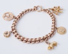 A 9ct yellow gold charm bracelet with four 9ct charms & one 18ct charm, charms include St