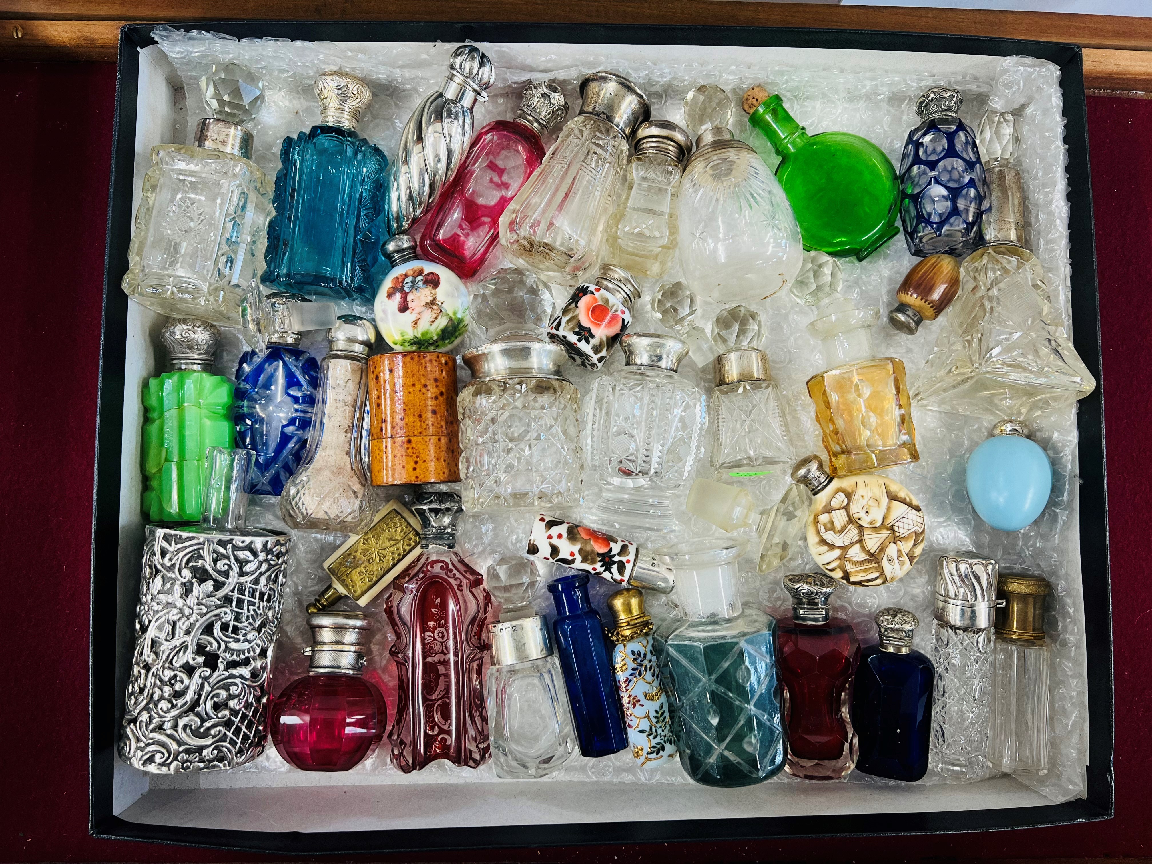 A collection of Victorian and later assorted scent bottles including silver, coloured glass,