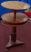 A 19th century mahogany rising three tier dumb waiter table on platform base, height 70cm.