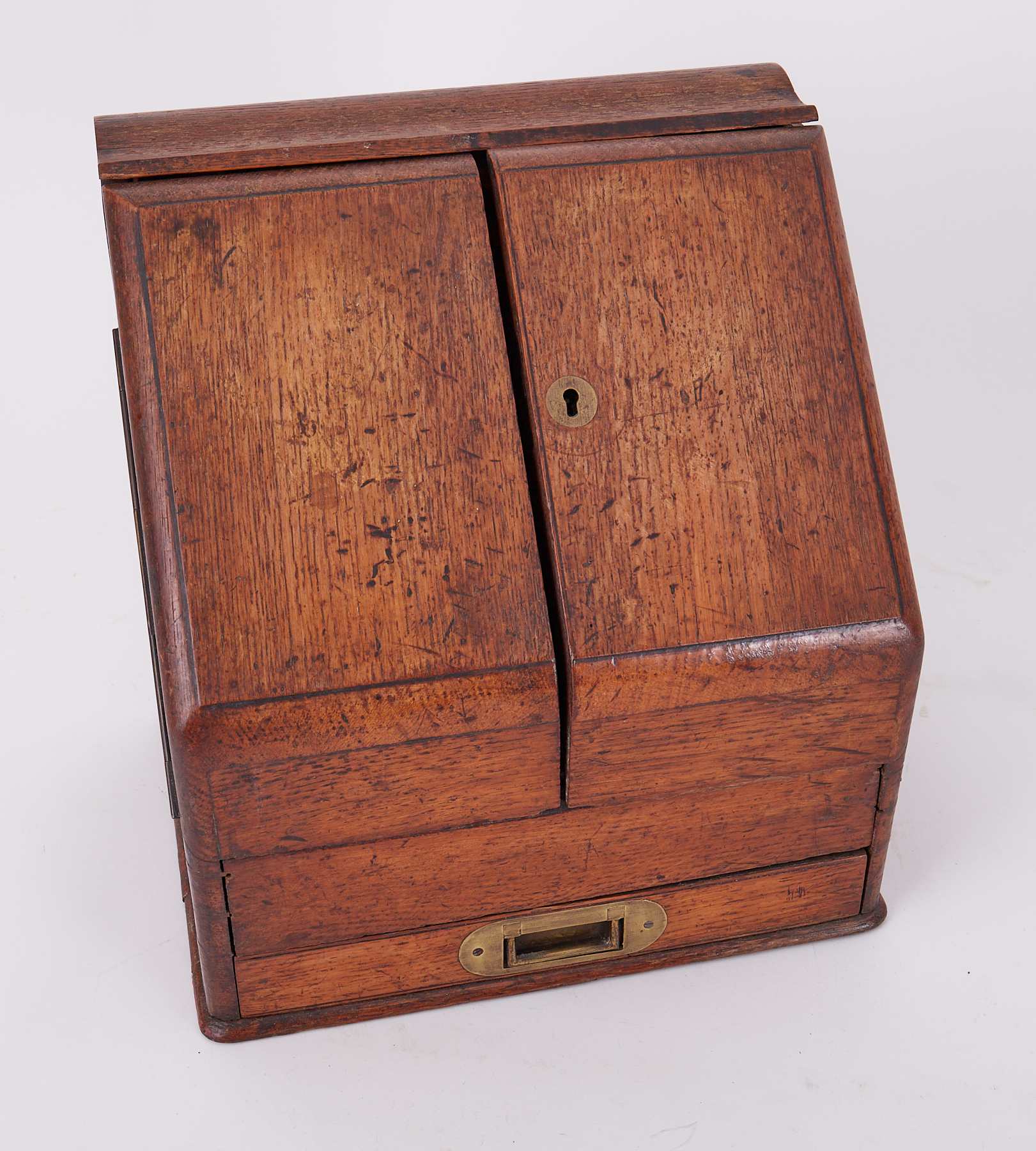 A Victorian oak stationary box fitted with various dividers and single drawer with a slope front,