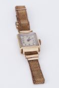 A vintage ladies mechanical wristwatch with mesh bracelet and gold case.