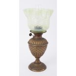A small brass oil lamp with green opaline twist glass shade.