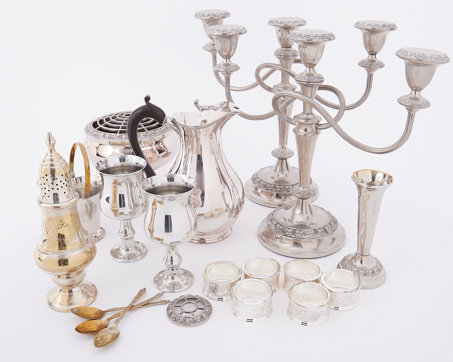 A small collection of silver plated wares including candelabra, napkin rings, sugar caster etc.