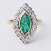 An 18ct yellow & white gold marquise shaped ring set with a central marquise shaped emerald, approx.