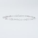 An 18ct white gold bracelet with 'arrow' style links interspaced with round brilliant cut diamonds