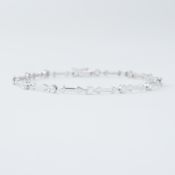 An 18ct white gold bracelet with 'arrow' style links interspaced with round brilliant cut diamonds