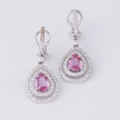 A pair of impressive 18ct white gold drop earrings each set with a central pear shaped pink