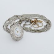 An ornately engraved Continental silver pocket watch with enamelled dial, inside of backplate