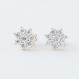 A pair of 18ct yellow gold flower design stud earrings set with round brilliant cut diamonds,