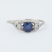 An 18ct white gold & platinum Art Deco ring set with a central round cut sapphire, approx. 0.76