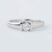 A platinum ring with a tension set 0.20 carat round brilliant cut diamond, 5.09gm, size H 1/2 to I.