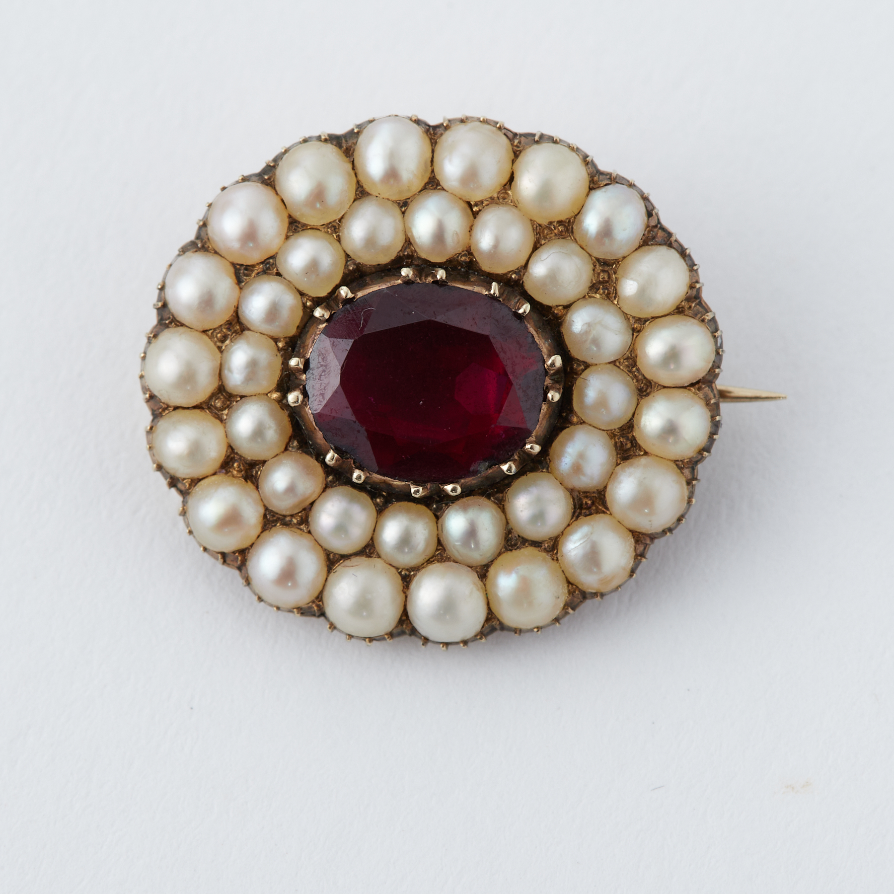 A Georgian yellow gold oval brooch set with a central oval cut garnet? measuring approx. 8mm x