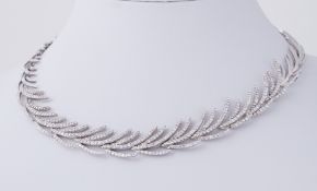 An impressive 18ct white gold 'feather' design choker style necklace set with approx. 6.47 carats of