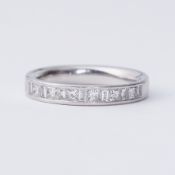 A platinum half eternity style ring set with alternating princess cut & baguette cut diamonds, total