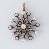 An antique yellow & white gold 'starburst' design pendant set with pearls and rose cut