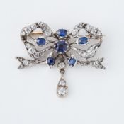 An antique white & yellow metal (no hallmarks & not tested) ornate bow design brooch set with